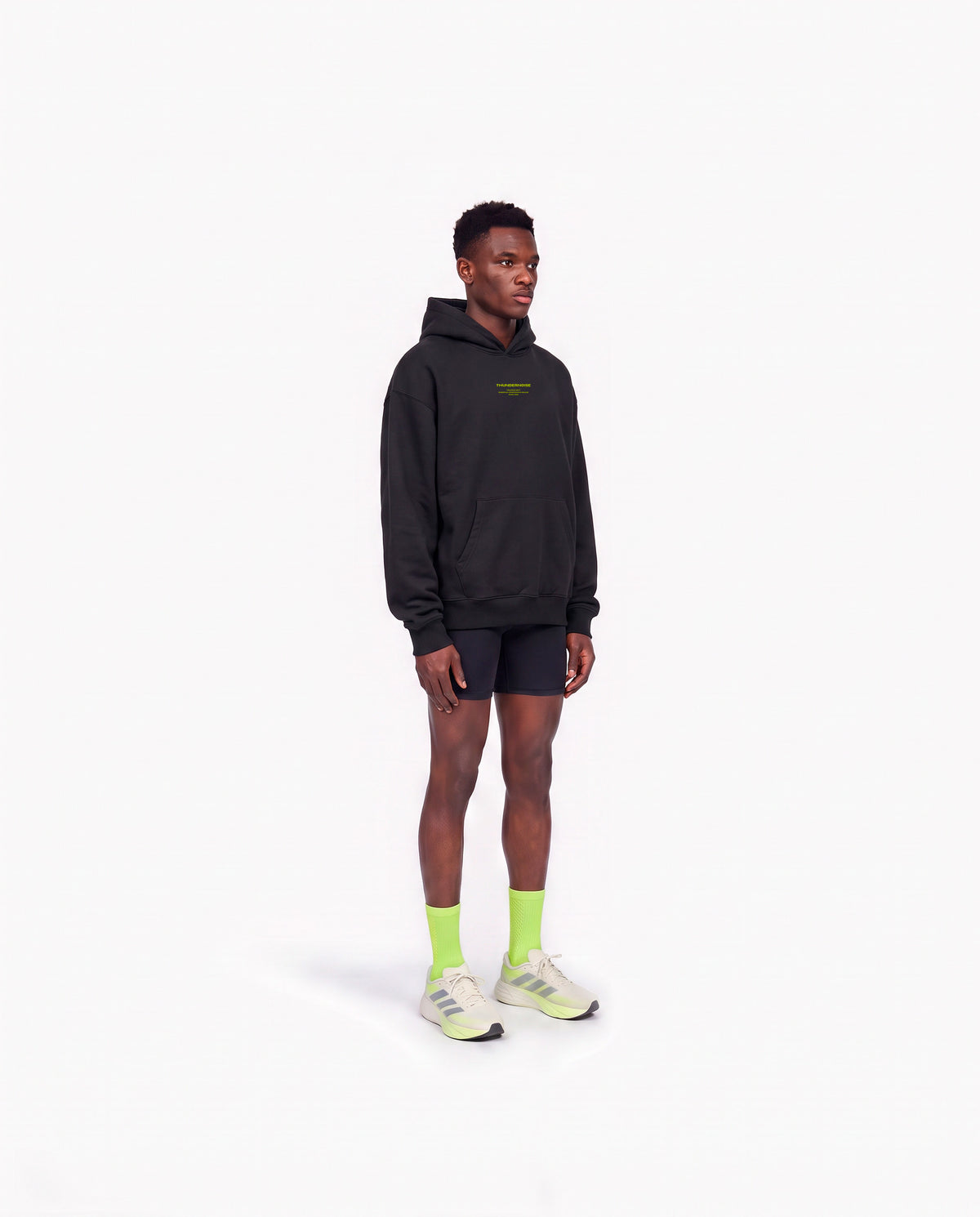 Model wearing the Brick by Brick oversize hoodie in black — three-quarter view showing the oversize fit — Ansicht 3