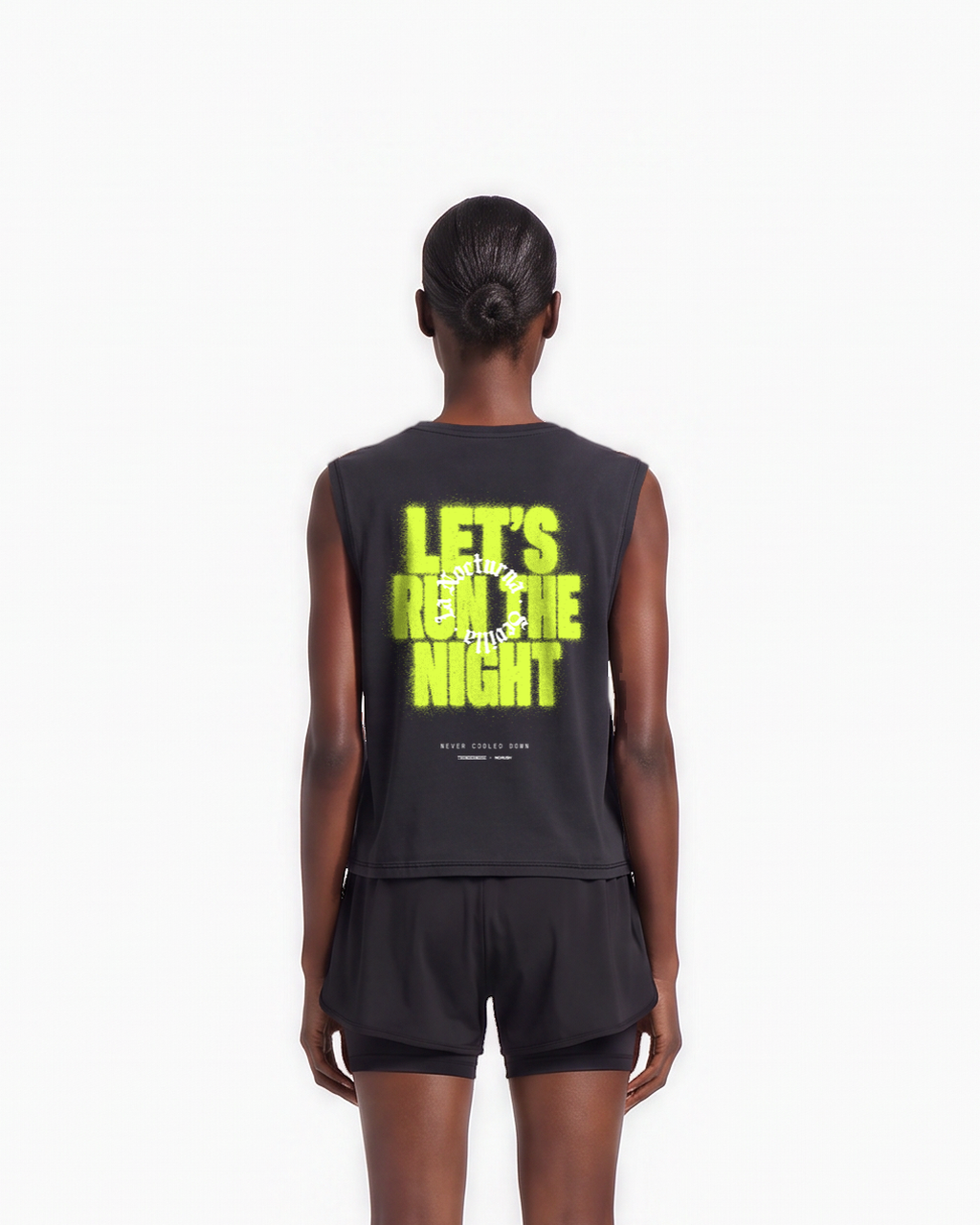 Model wearing the Let's Run the Night cropped tank top in black — back view, close crop on LET'S RUN THE NIGHT sprayed in electric lime around the La Nocturna Sevilla seal — Ansicht 7