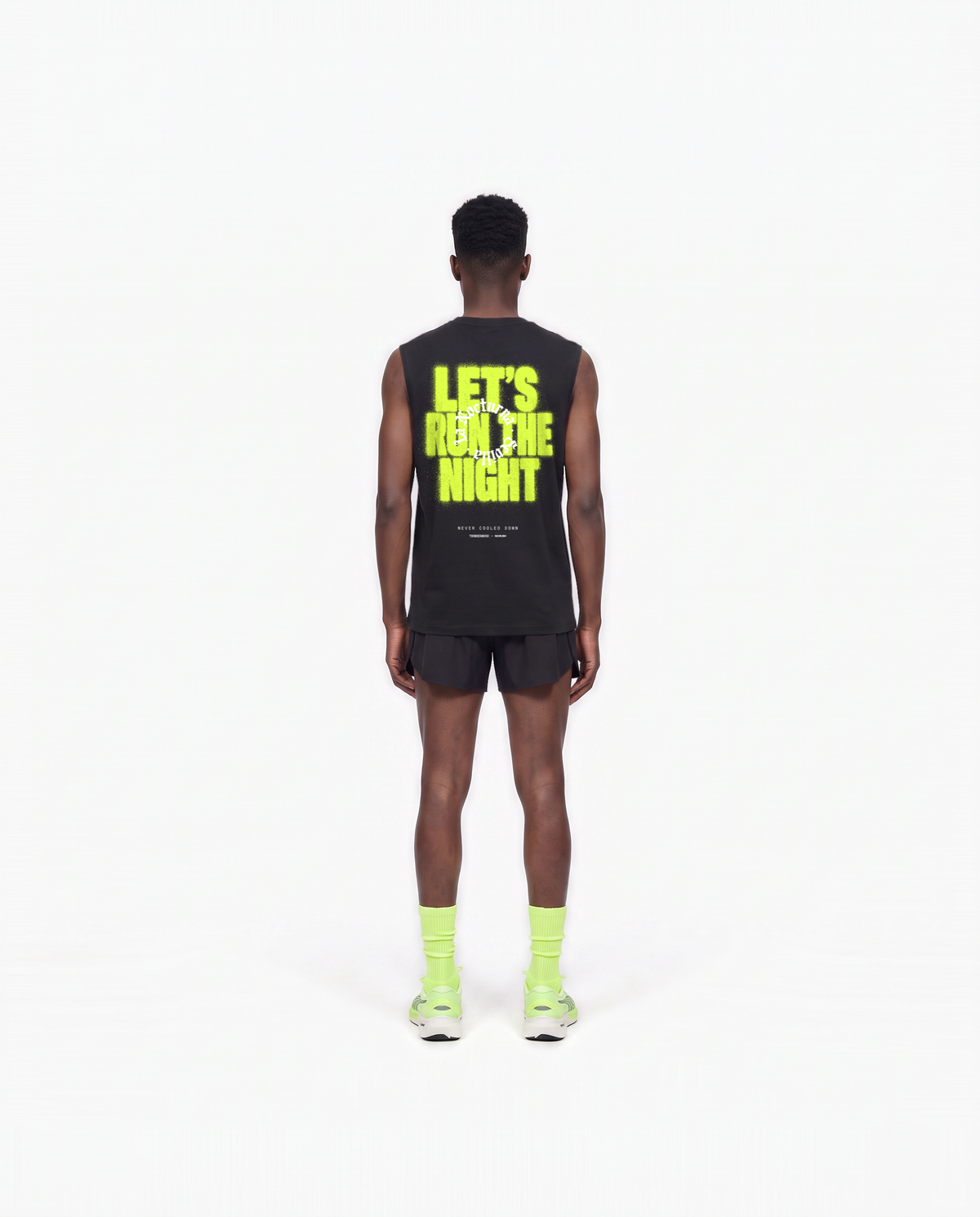 Model wearing the Let's Run the Night tank top in black — back view with LET'S RUN THE NIGHT sprayed in electric lime around the La Nocturna Sevilla seal — Ansicht 6