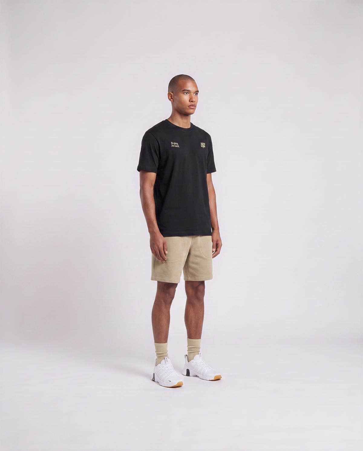 Model wearing the No Glory Just Work t-shirt in black — three-quarter view showing the regular fit — Ansicht 3