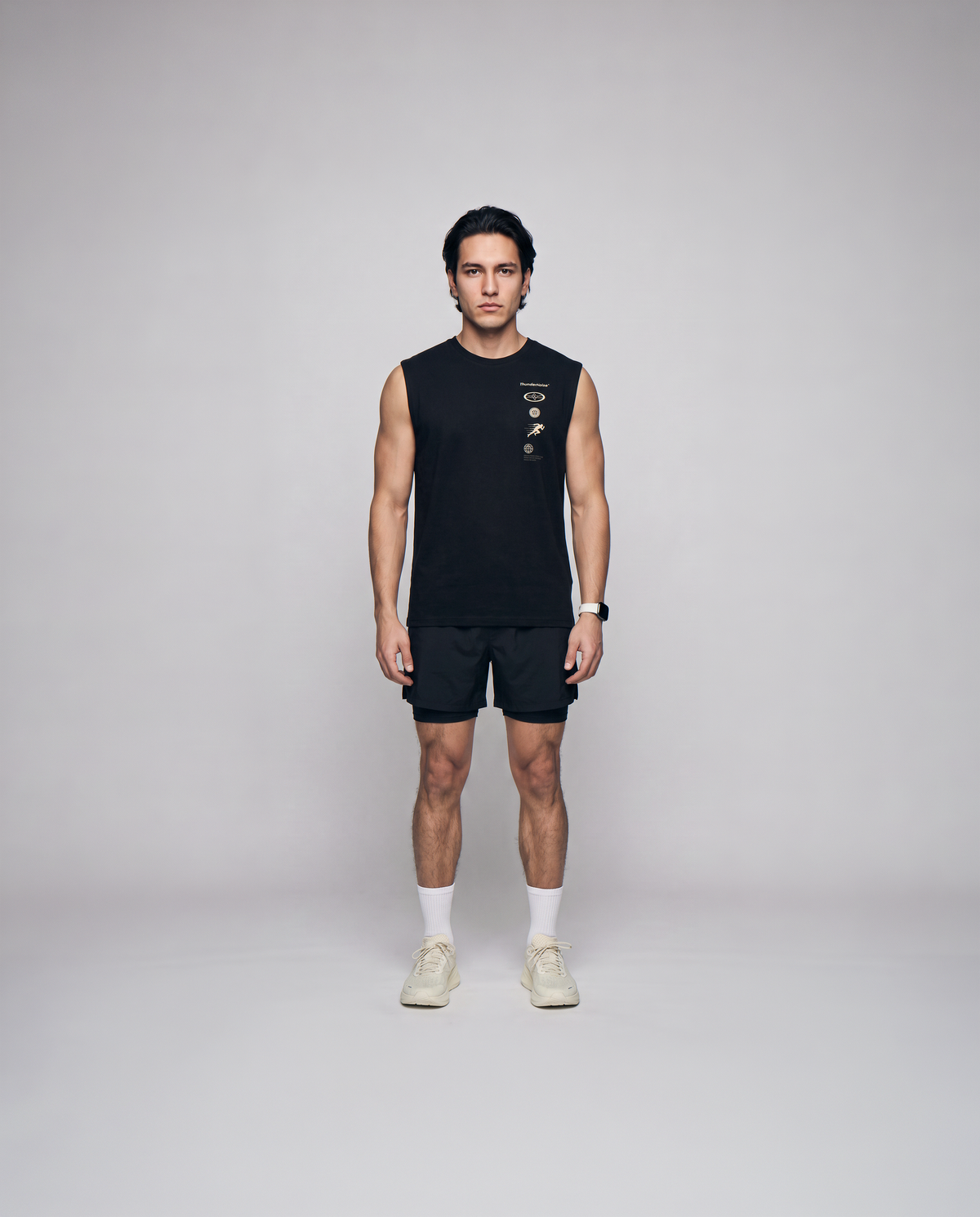 Model wearing the Strong Enough to Run tank top in black — front view with the right-chest marker column in sand and grey — Ansicht 4
