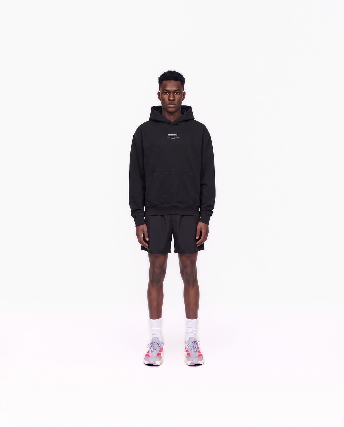 Model wearing the Today Was My Rest Day oversize hoodie in black — front view with the compact Thundernoise chest mark in white — Vue 2