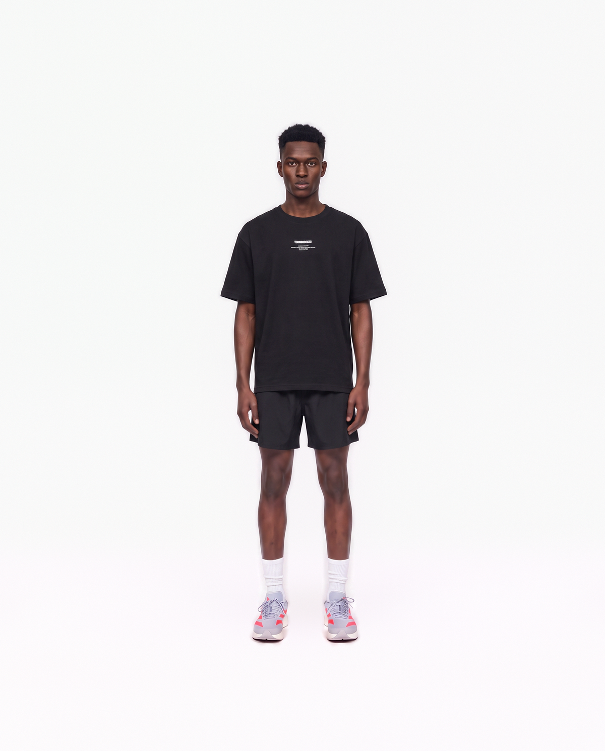 Model wearing the Today Was My Rest Day oversize t-shirt in black — front view with the compact Thundernoise chest mark in white — Vue 2