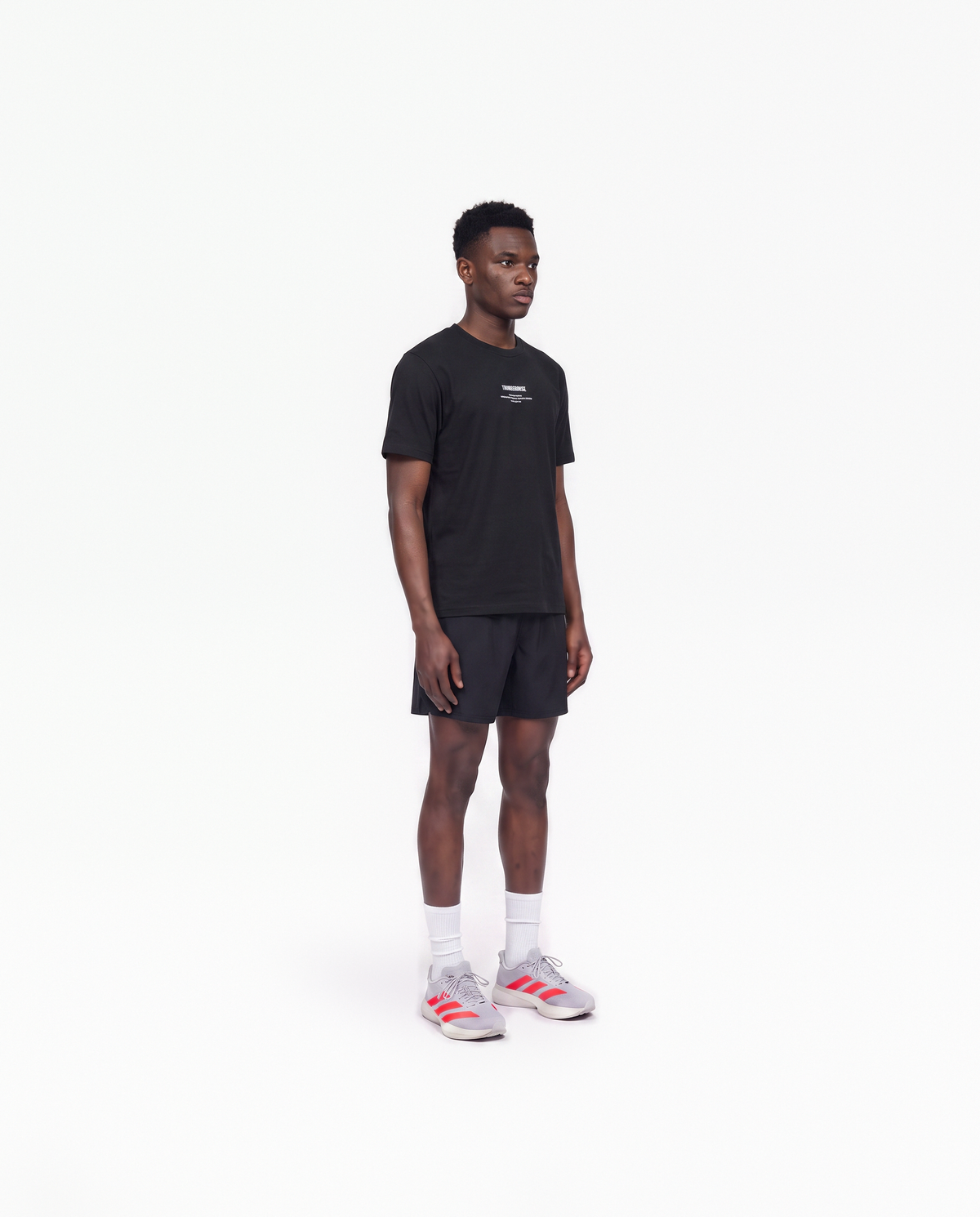 Model wearing the Today Was My Rest Day t-shirt in black — three-quarter view showing the regular fit — Vue 3