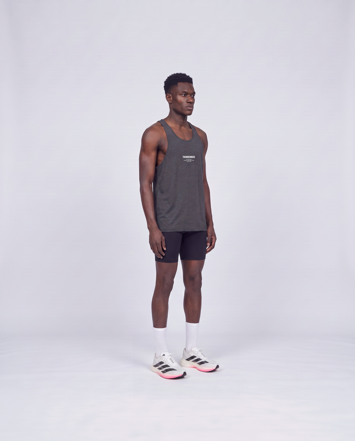 Training Dept. triblend tank top in dark grey heather on model — three-quarter view — Vue 3
