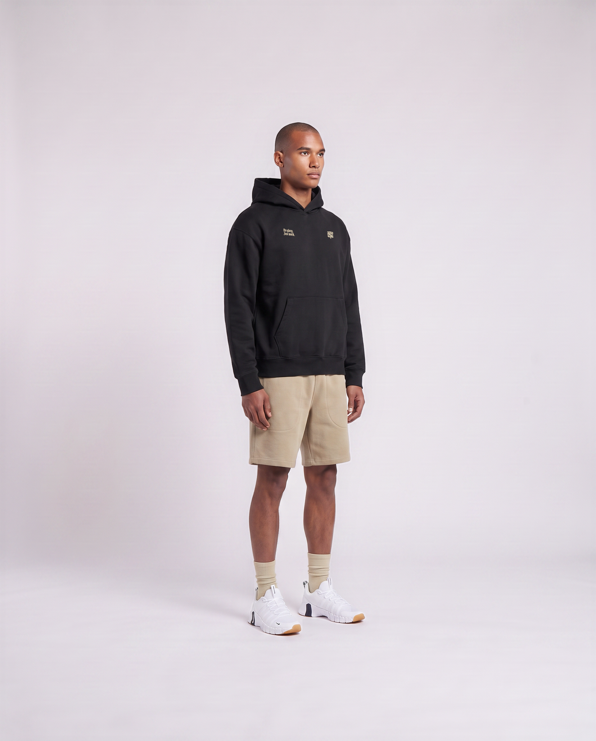Model wearing the No Glory Just Work oversize hoodie in black — three-quarter view showing the oversize fit — Ansicht 3
