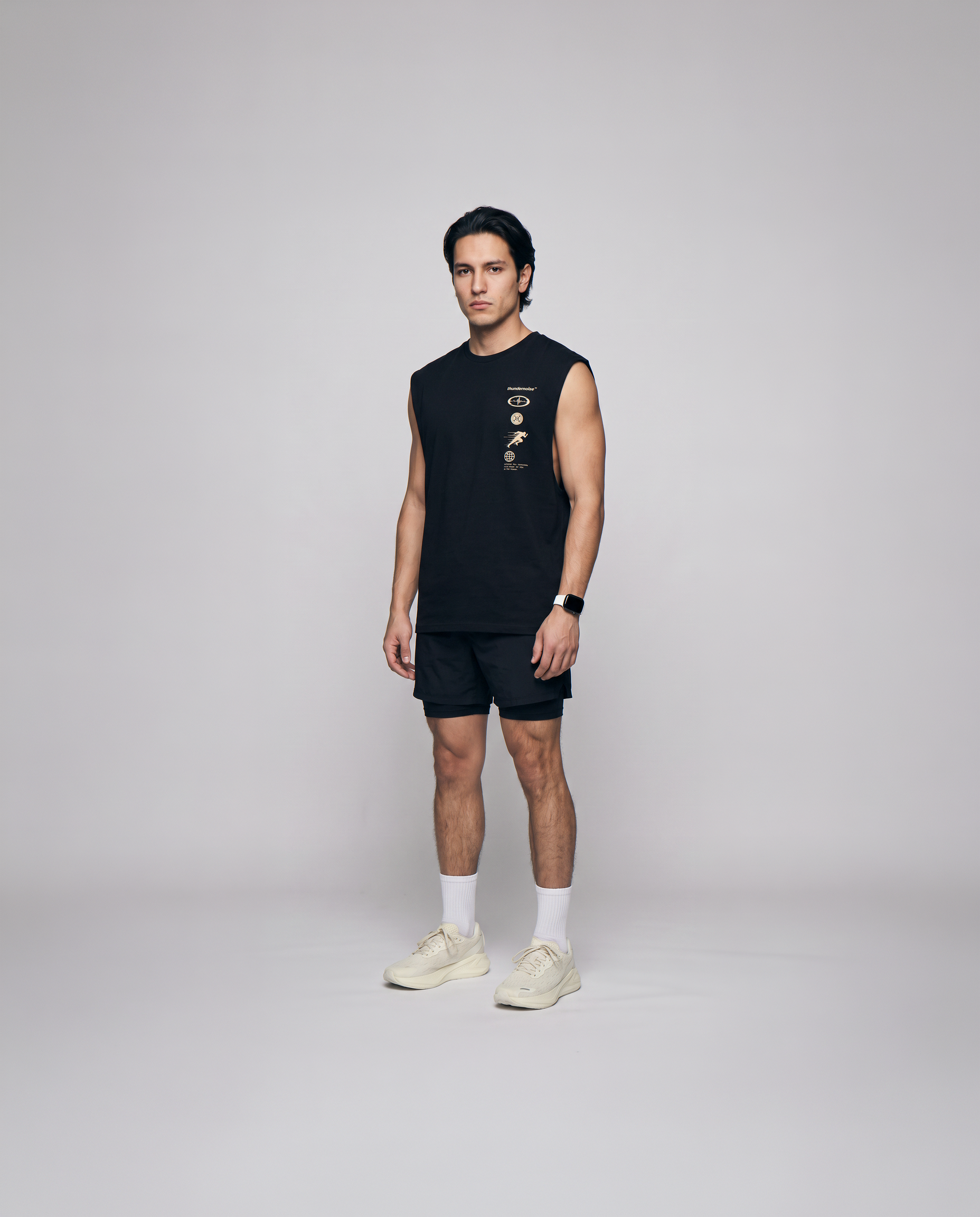 Model wearing the Strong Enough to Run tank top in black — three-quarter view showing the sleeveless cut