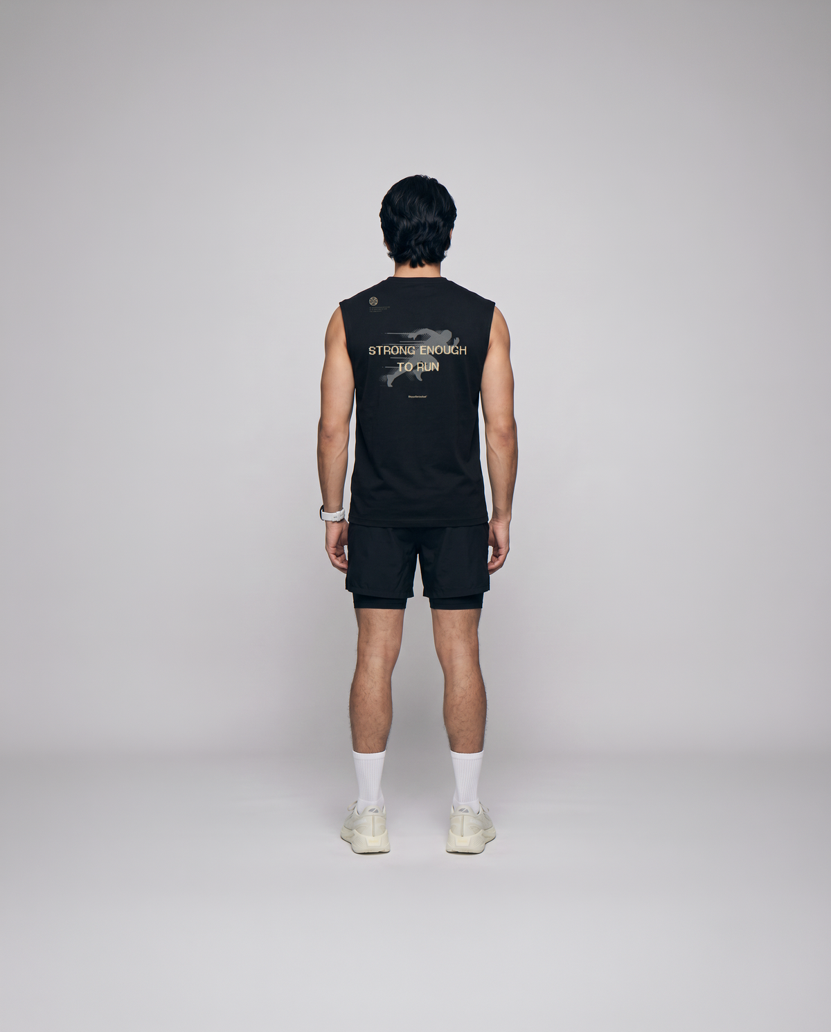 Model wearing the Strong Enough to Run tank top in black — back view with the STRONG ENOUGH TO RUN halftone runner print — Vista 3
