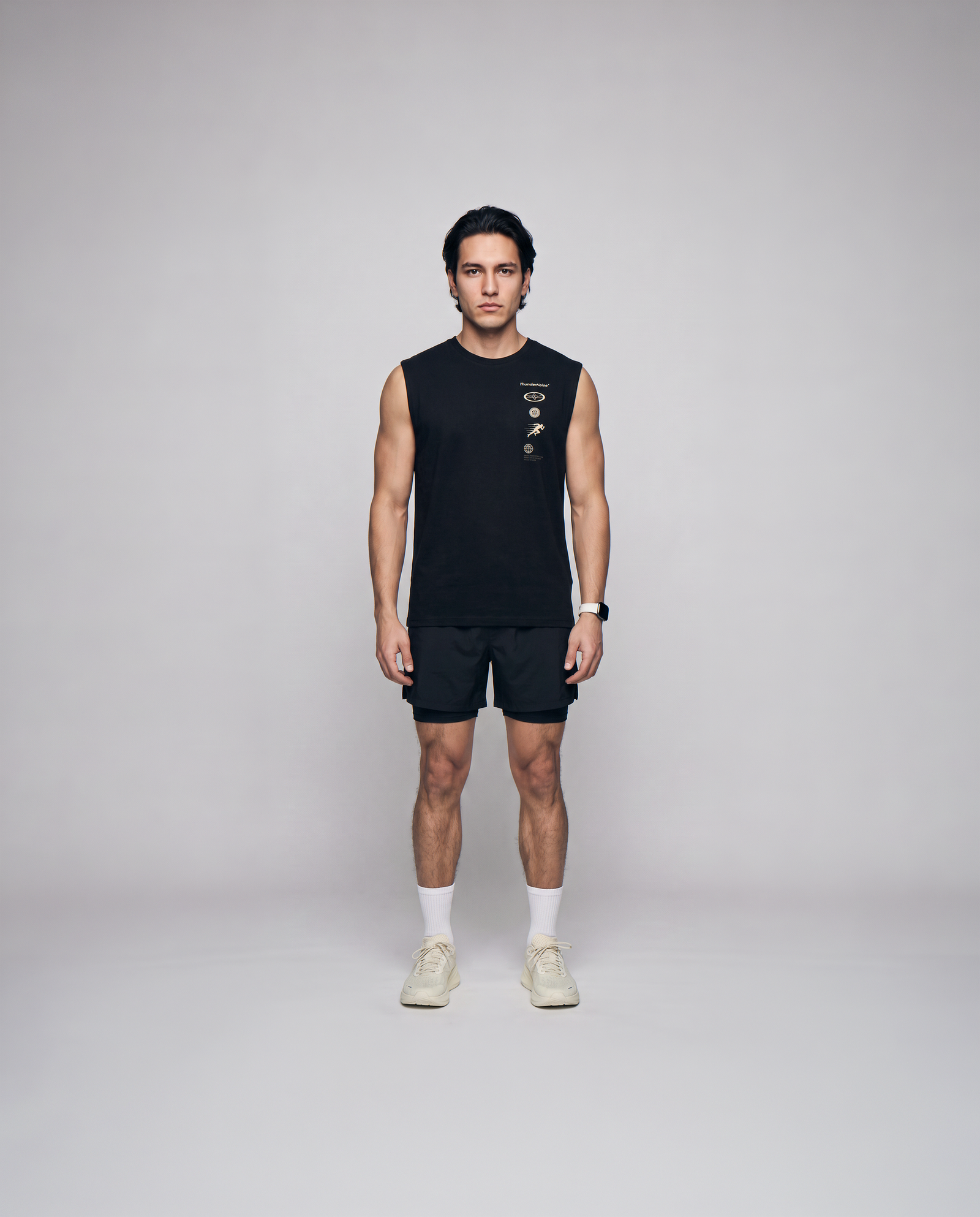 Model wearing the Strong Enough to Run tank top in black — front view with the right-chest marker column in sand and grey — Vista 4
