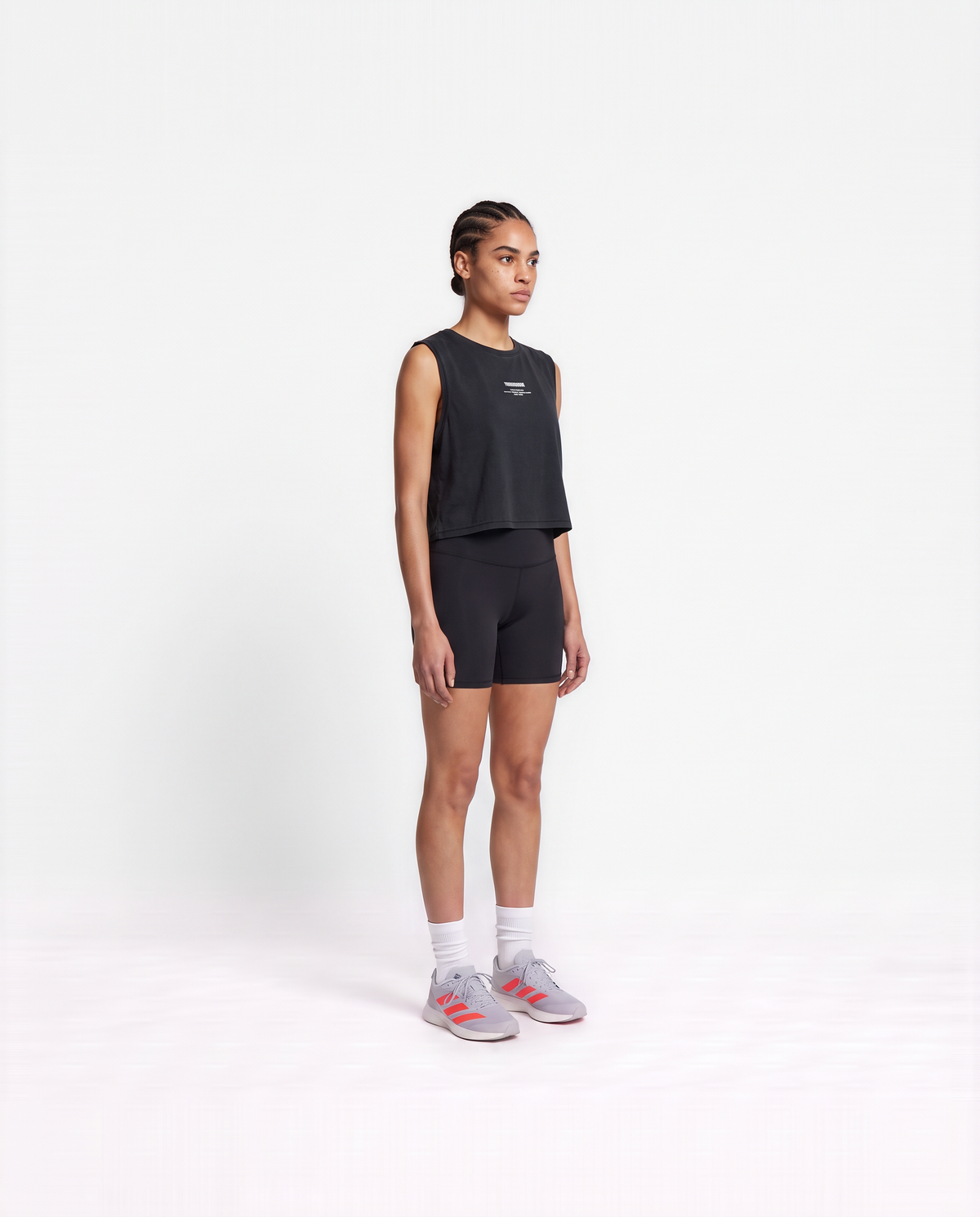 Model wearing the Today Was My Rest Day cropped tank top in black — three-quarter view showing the cropped fit — Ansicht 3
