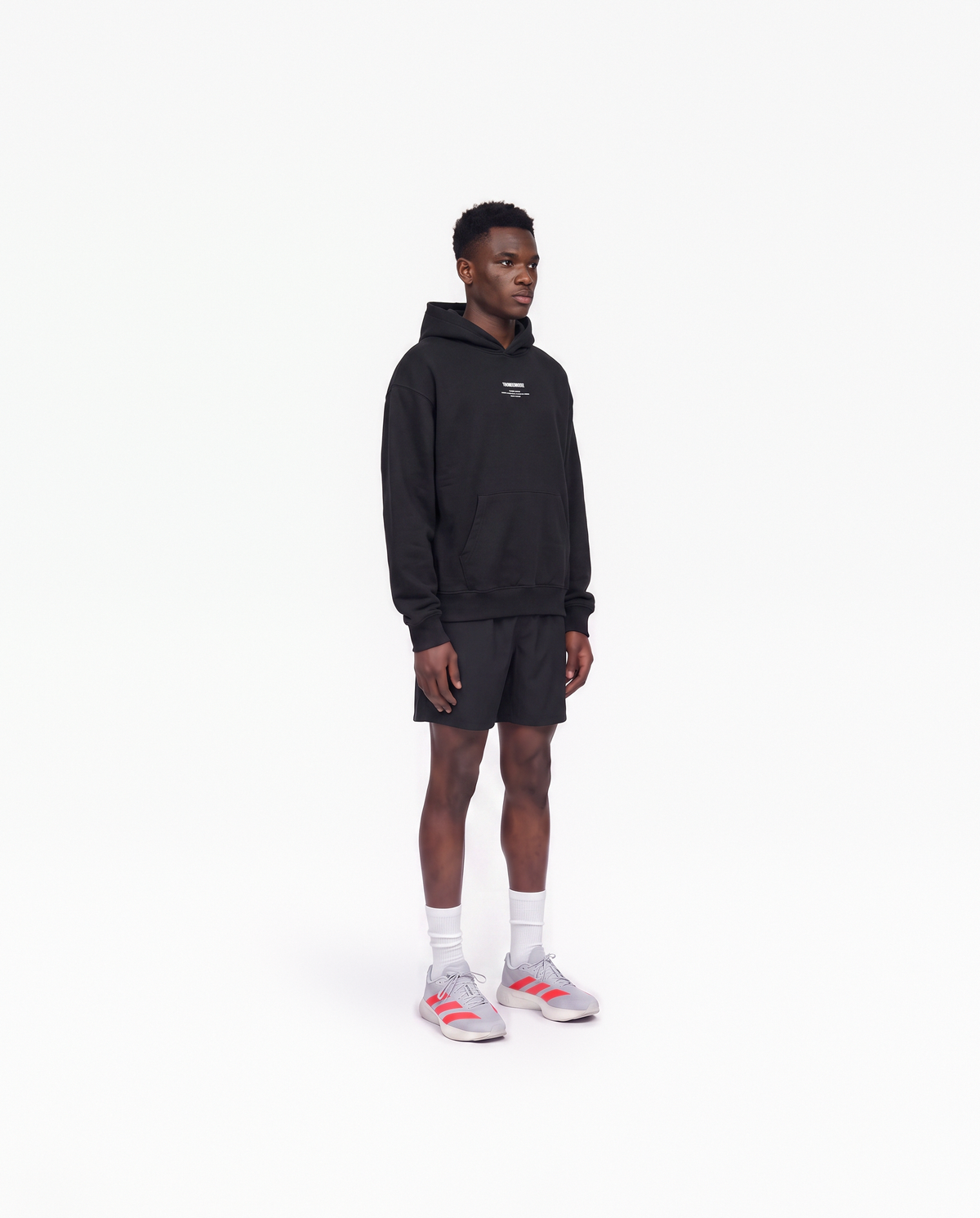 Model wearing the Today Was My Rest Day oversize hoodie in black — three-quarter view showing the oversize fit — Vue 3
