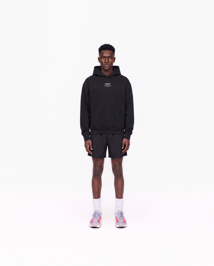 Model wearing the Today Was My Rest Day oversize hoodie in black — front view with the compact Thundernoise chest mark in white