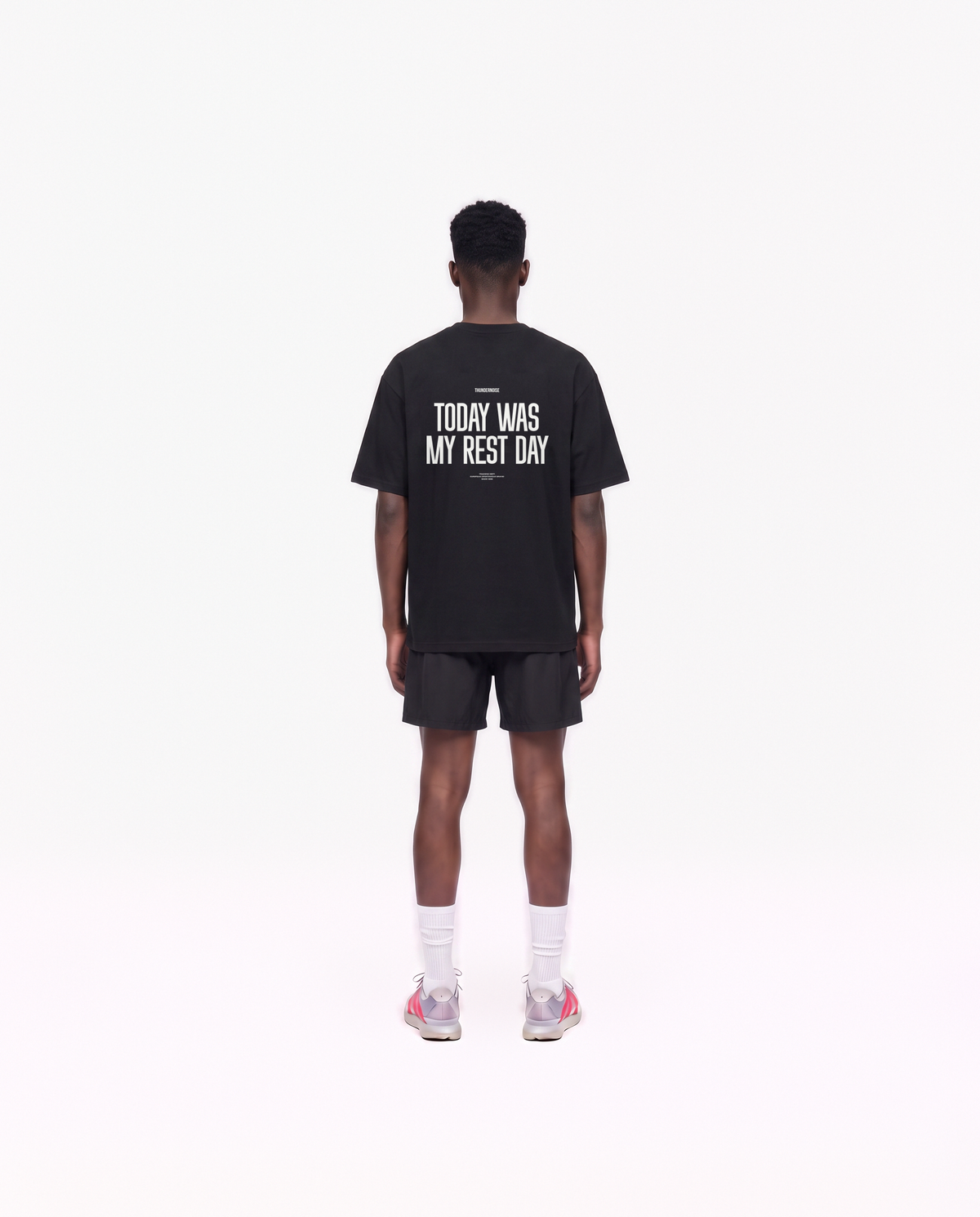 Model wearing the Today Was My Rest Day oversize t-shirt in black — back view with the TODAY WAS MY REST DAY block in white — Vue 4
