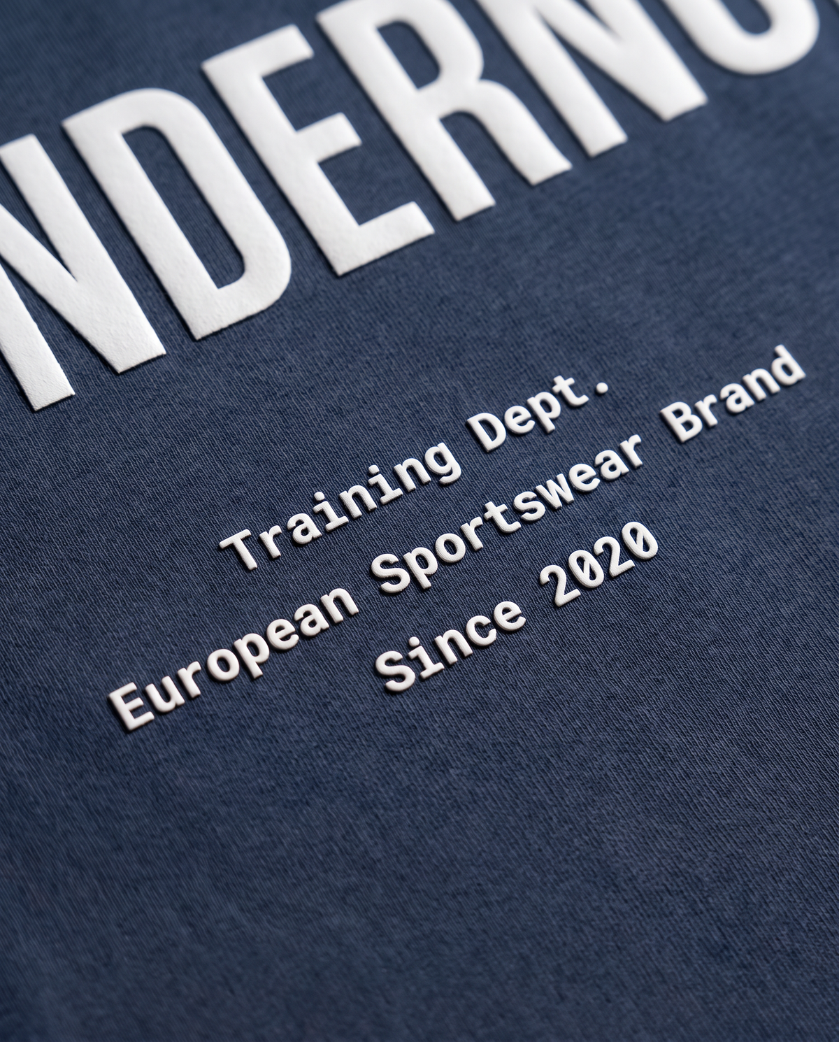 Training Dept. triblend t-shirt in french navy heather — close-up of the raised high-density print on the back — View 5
