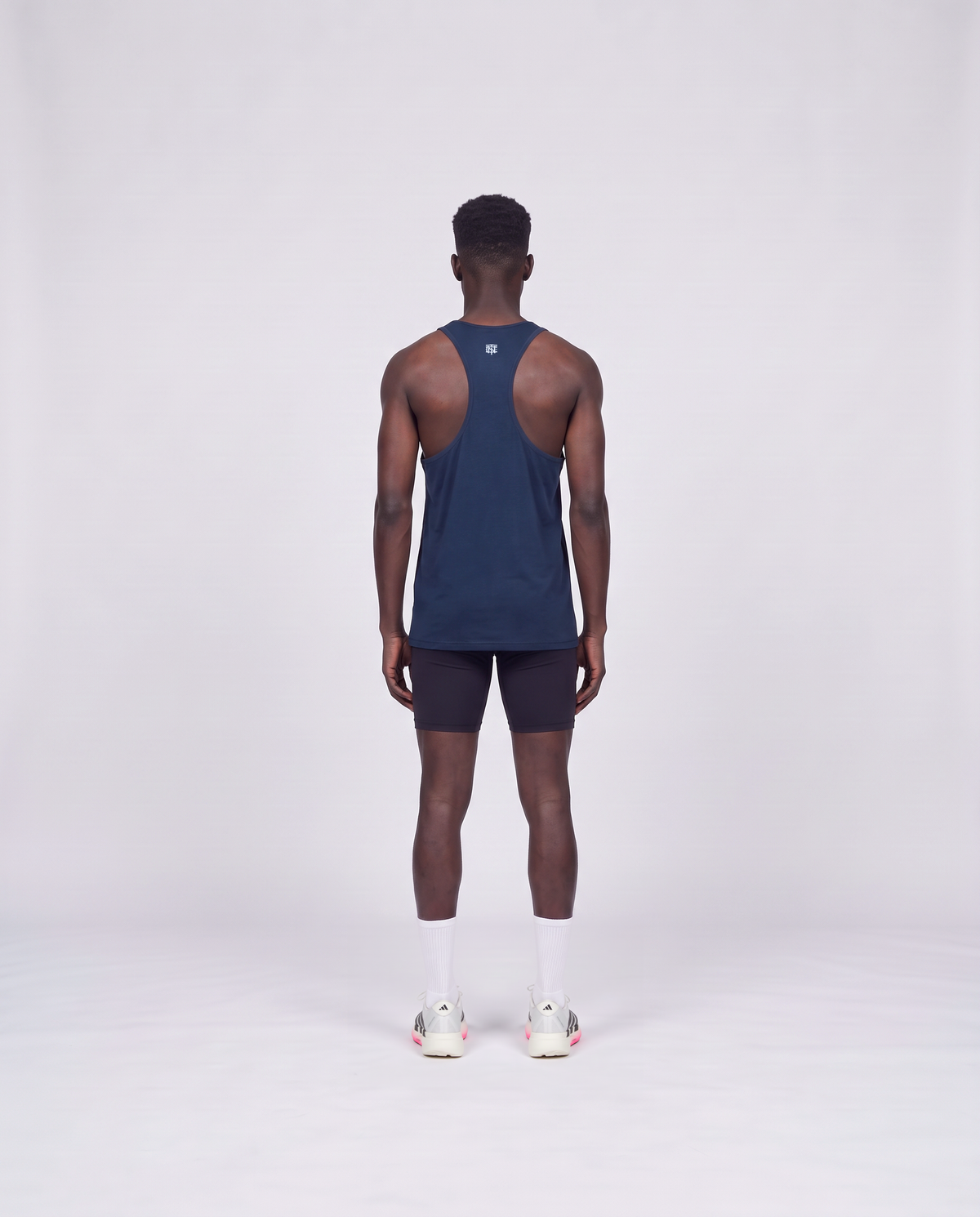 Training Dept. triblend tank top in french navy heather on model — back view — Vista 4
